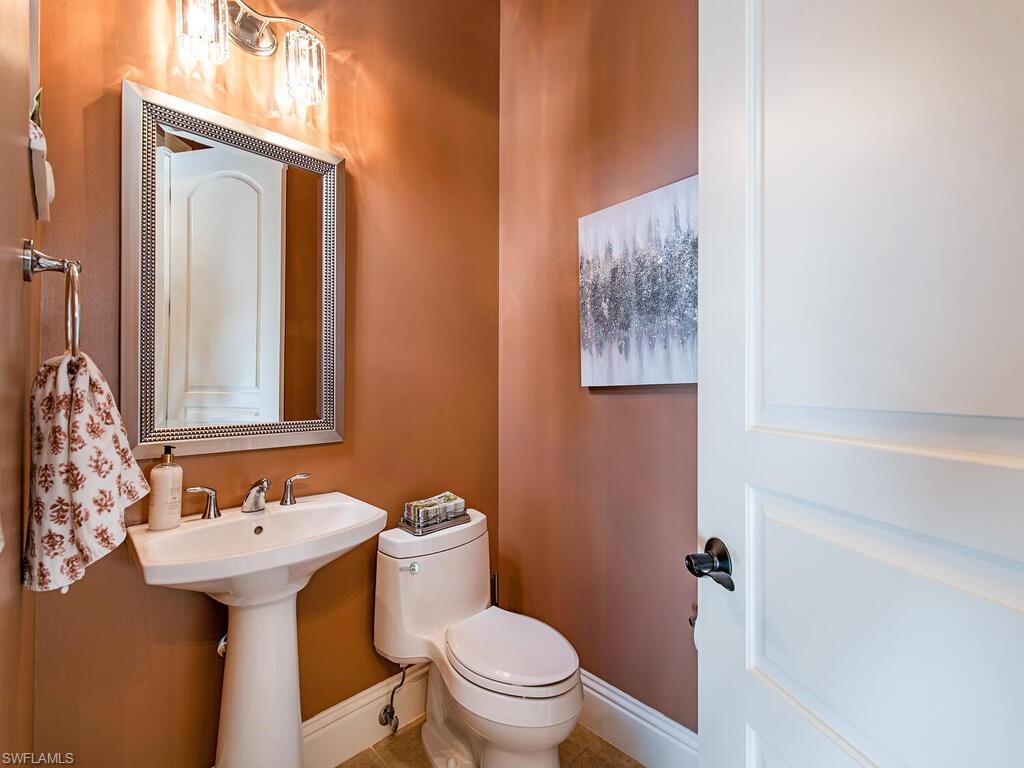 8000 Cordoba Place Naples, FL 34113 - Photo 13 of 16 a bathroom with a sink toilet and mirror