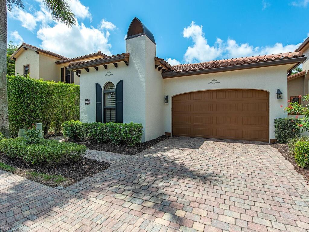 8000 Cordoba Place Naples, FL 34113 - Photo 2 of 16 a front view of a house with a yard