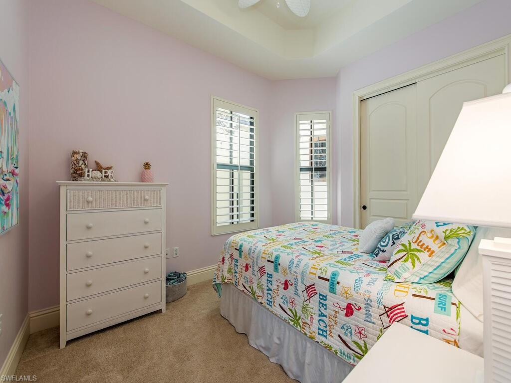 8000 Cordoba Place Naples, FL 34113 - Photo 10 of 16 a bedroom with a bed and a window