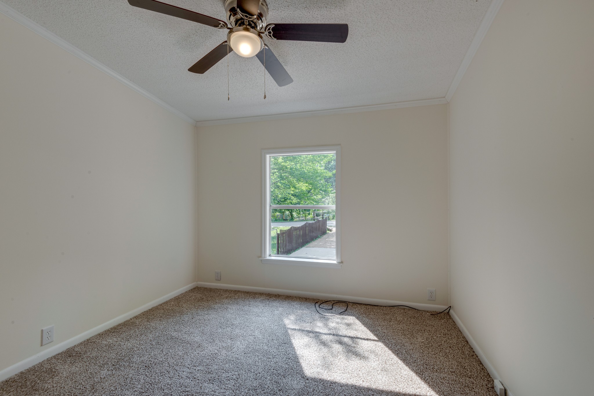 211 Hillcrest Road Kingston Springs, TN 37082 - Photo 19 of 28 an empty room with a window and a fan
