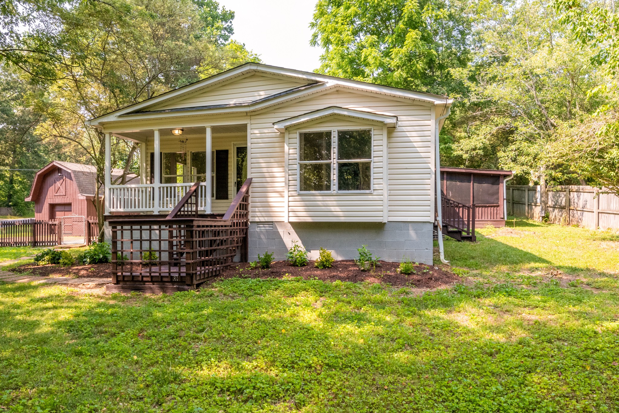 211 Hillcrest Road Kingston Springs, TN 37082 - Photo 3 of 28 a front view of a house with a yard table and chairs