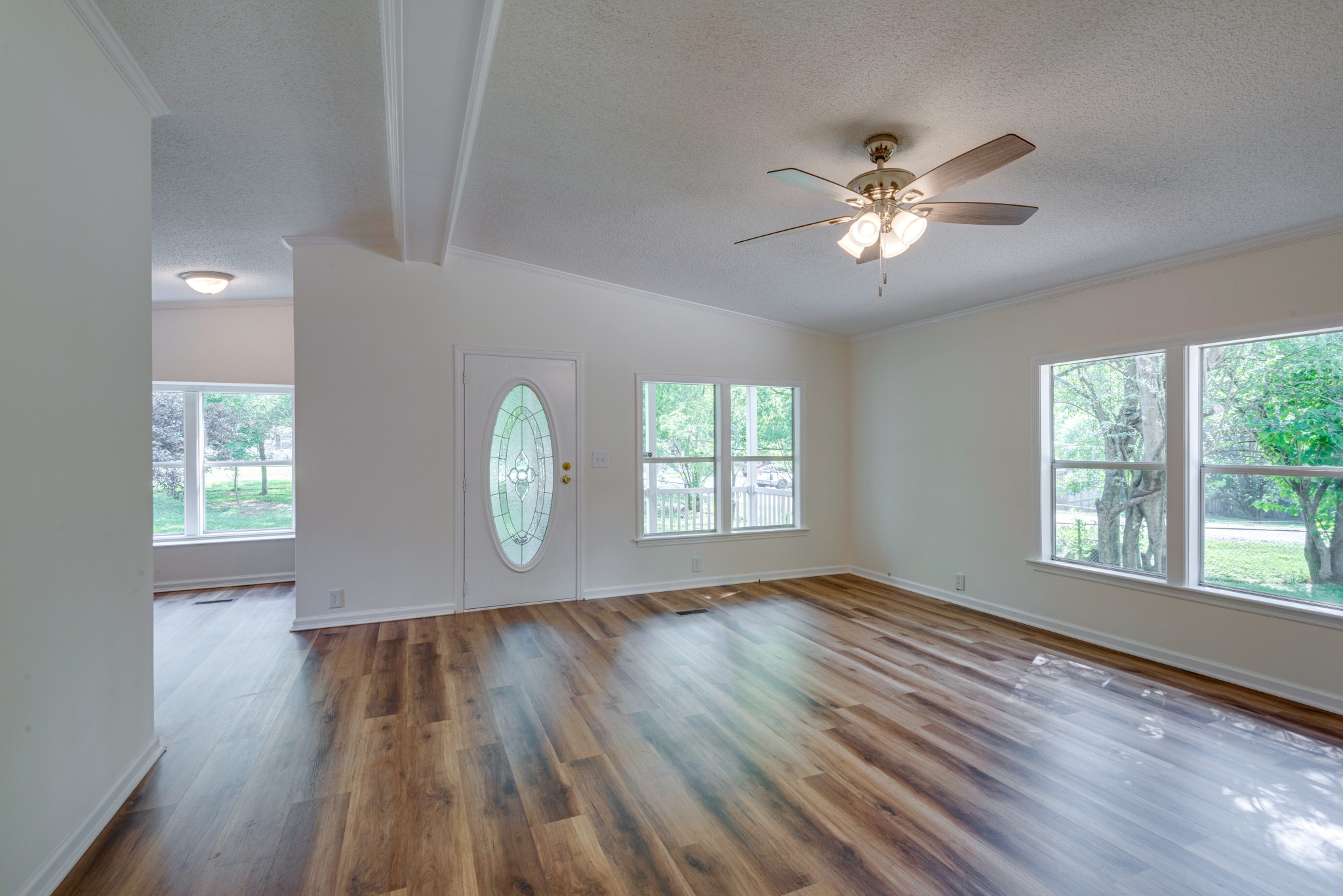 211 Hillcrest Road Kingston Springs, TN 37082 - Photo 4 of 28 a view of an empty room with wooden floor and a window