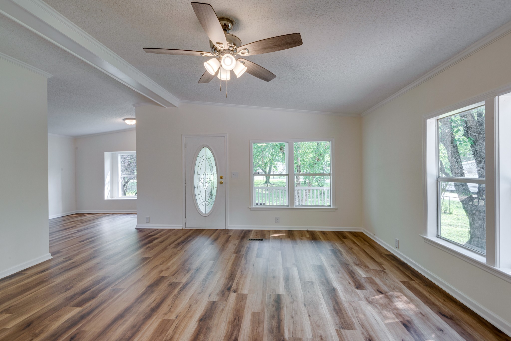 211 Hillcrest Road Kingston Springs, TN 37082 - Photo 5 of 28 a view of an empty room with wooden floor and a window