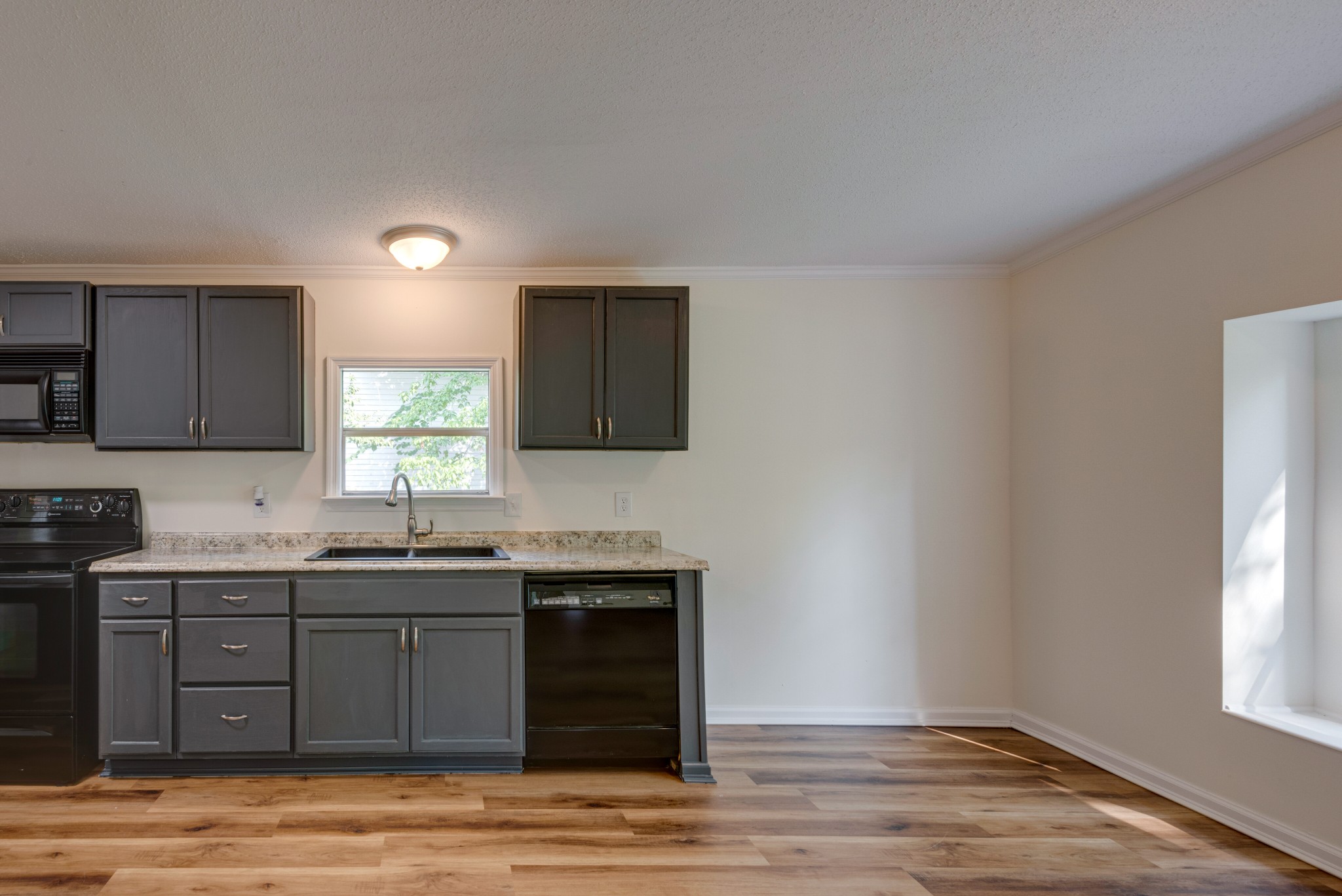 211 Hillcrest Road Kingston Springs, TN 37082 - Photo 8 of 28 a kitchen with stainless steel appliances granite countertop a sink stove and cabinets