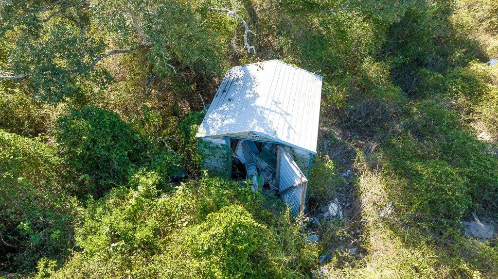 2277 Johnson Road Aransas Pass, TX 78336 - Photo 13 of 27 a view of a house with a small yard and large trees
