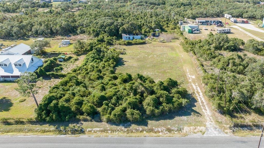 2277 Johnson Road Aransas Pass, TX 78336 - Photo 2 of 27 a view of a yard with plants and large trees