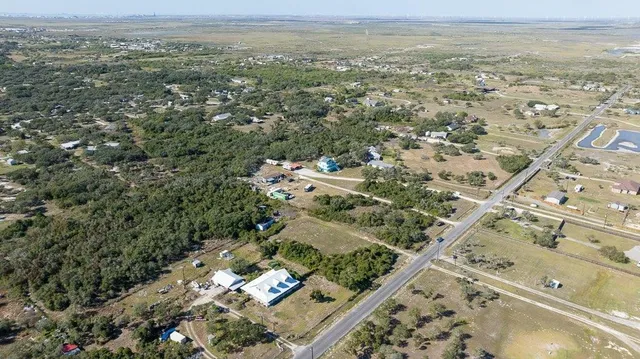 an aerial view of a residential houses with outdoor space