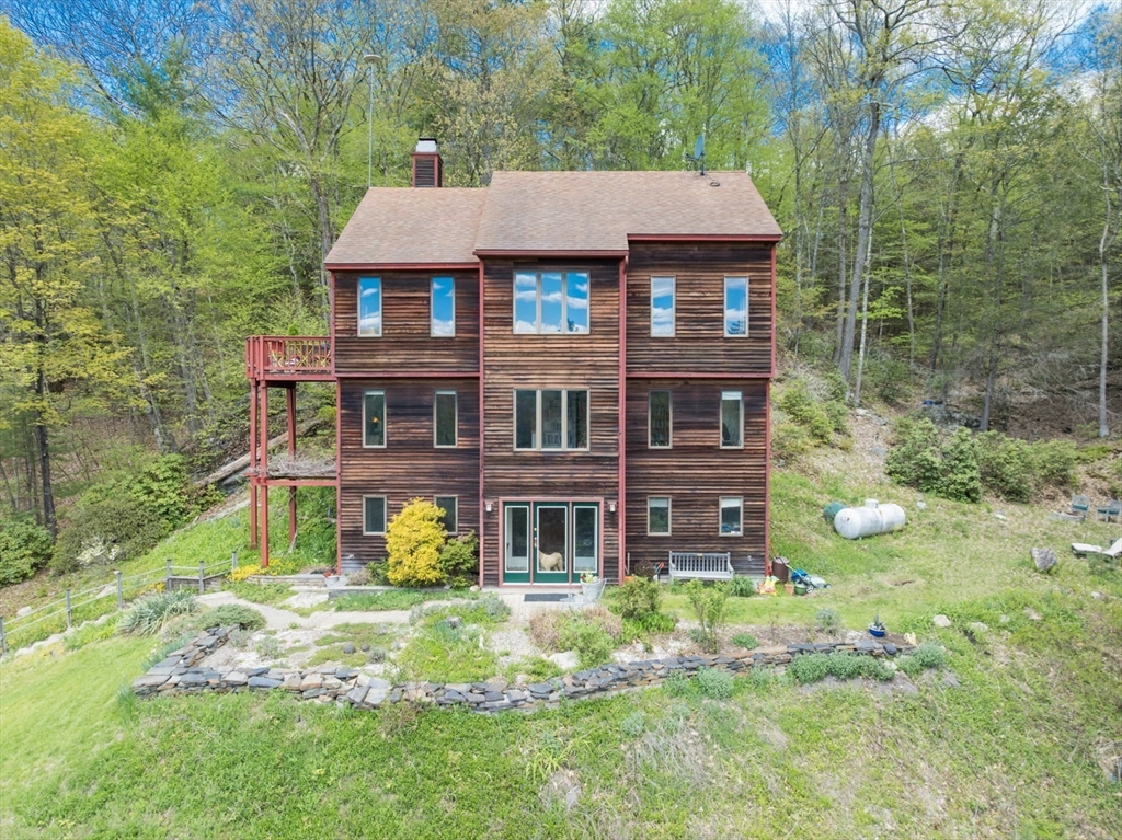 247 Montague Road Leverett, MA 01054 - Photo 2 of 40 a front view of a house with garden