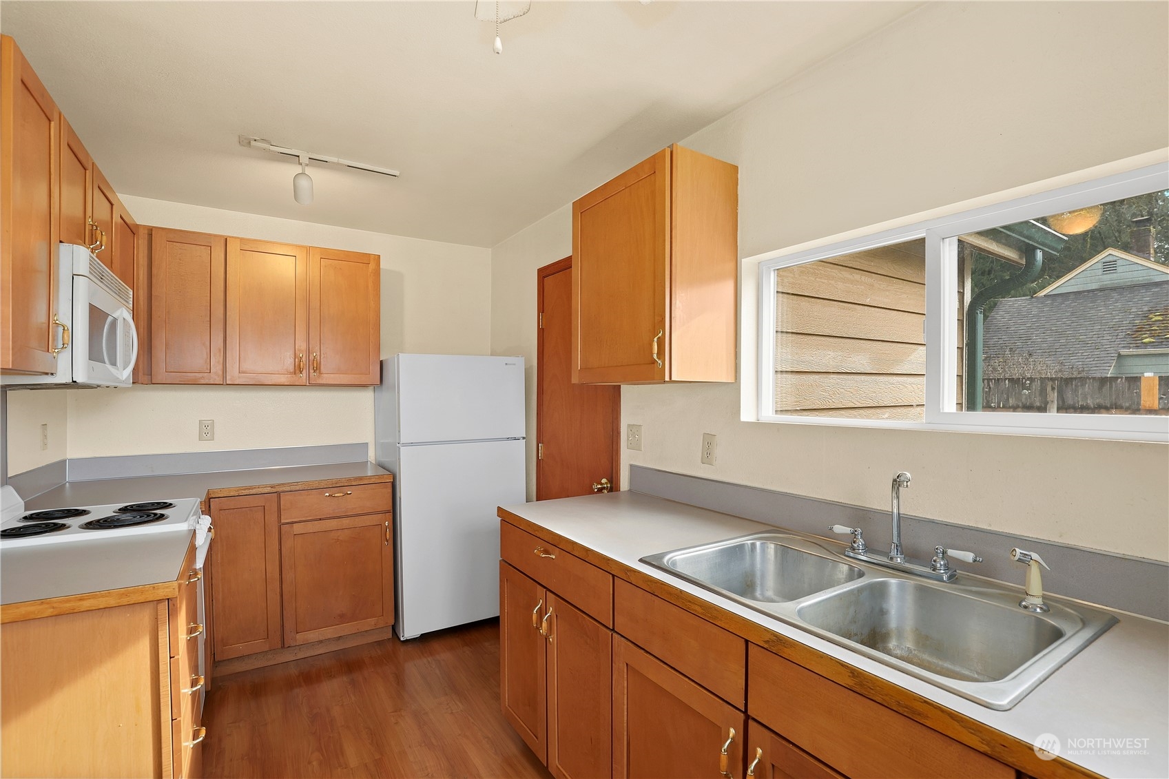3640 Gull Harbor Road Northeast Olympia, WA 98506 - Photo 12 of 28 a kitchen that has a sink cabinets counter space and a window