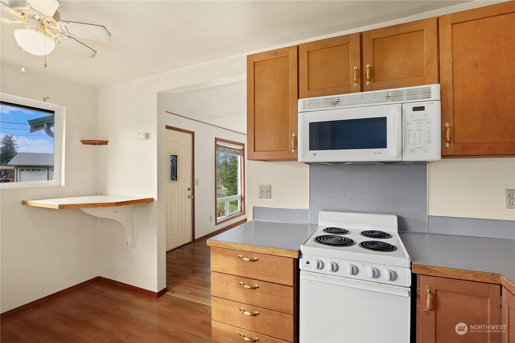 3640 Gull Harbor Road Northeast Olympia, WA 98506 - Photo 15 of 28 a kitchen with a stove and a microwave