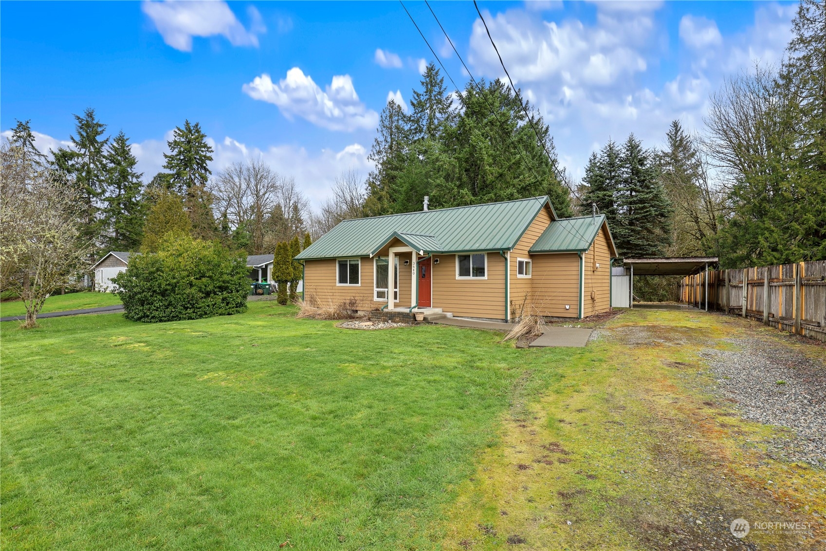 3640 Gull Harbor Road Northeast Olympia, WA 98506 - Photo 2 of 28 a view of a yard with table and chairs plants and large trees