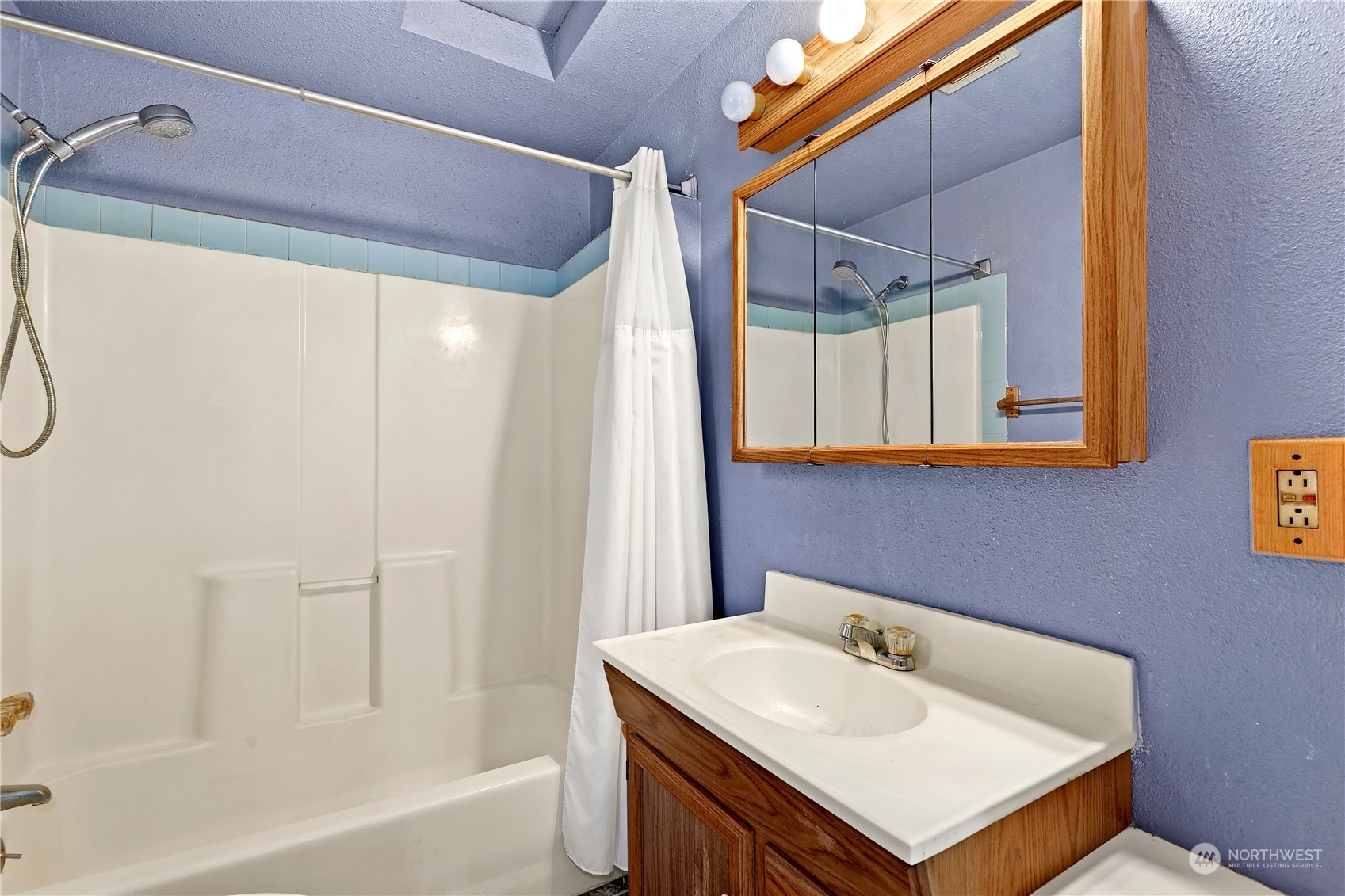 3640 Gull Harbor Road Northeast Olympia, WA 98506 - Photo 22 of 28 a bathroom with a sink a mirror and a shower