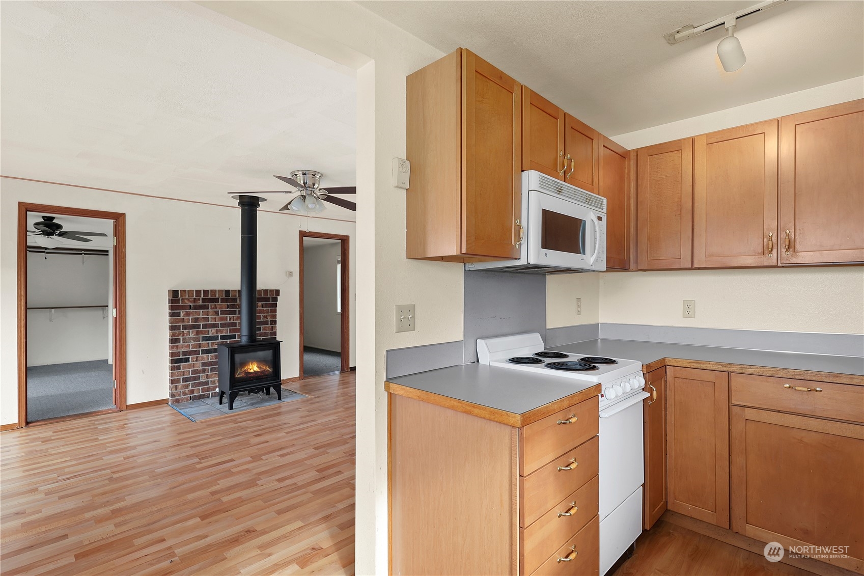 3640 Gull Harbor Road Northeast Olympia, WA 98506 - Photo 10 of 28 a kitchen with stainless steel appliances granite countertop a stove a sink and a microwave