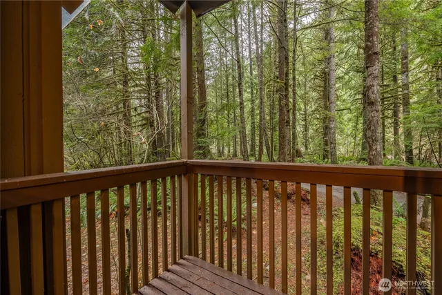 a view of a balcony with wooden floor and fence