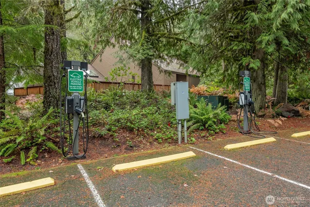 a front view of a house with a yard and tree