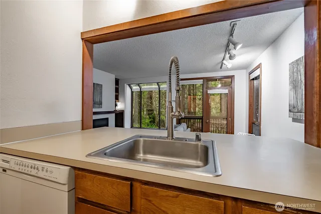 a kitchen with a sink and large window