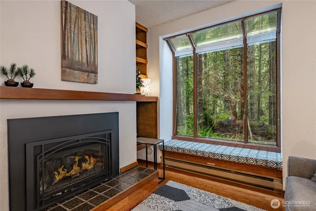 a living room with a fireplace and large windows