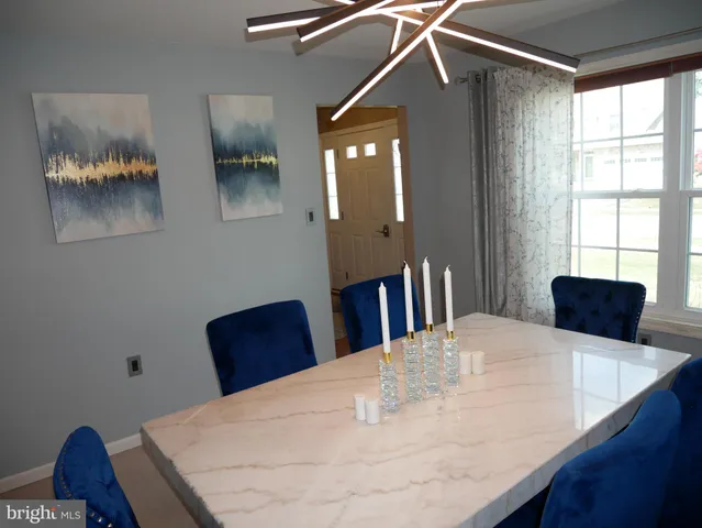 a view of a livingroom with furniture and staircase