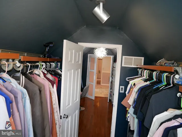 a bedroom with a bed and a flat tv screen on the dresser