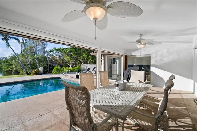 a view of a dining room with furniture wooden floor and chandelier