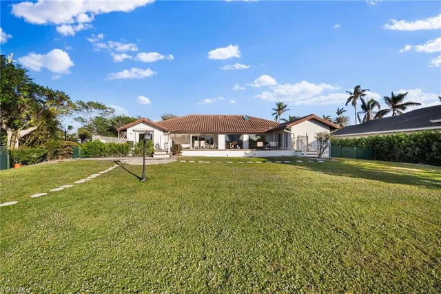 a swimming pool with outdoor seating and yard