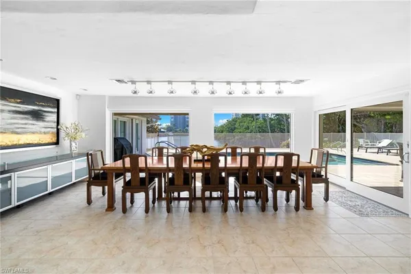 a large dining space with furniture window and wooden floor