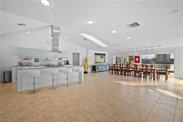 a kitchen with stainless steel appliances kitchen island granite top and refrigerator
