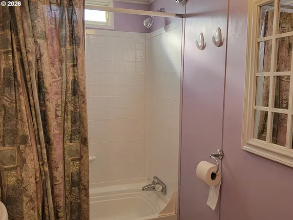 a bathroom with a shower and a tub