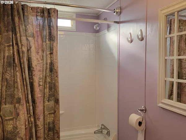 a bathroom with a shower and a tub