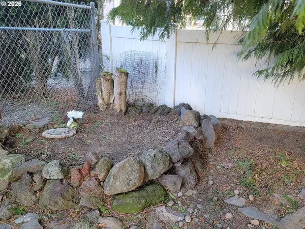 a view of swimming pool with a garden and plants