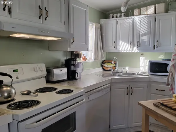 a kitchen with a stove a sink and cabinets