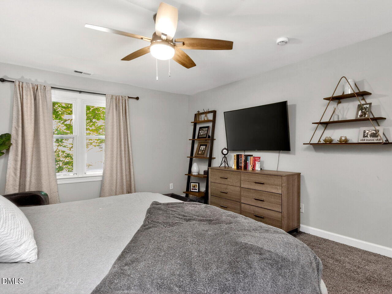 6004 Tarnhour Court Raleigh, NC 27612 - Photo 19 of 44 a bedroom with furniture and flat screen tv