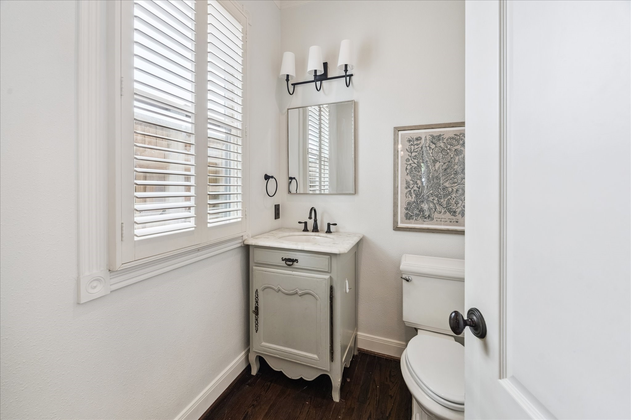 3818 Case Street West University Place, TX 77005 - Photo 15 of 29 a bathroom with a sink a toilet a mirror and a window