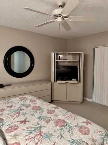 a bedroom with a bed and a wooden floor