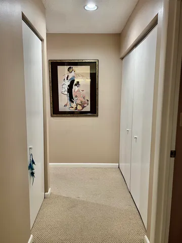 an empty room with painting on the wall