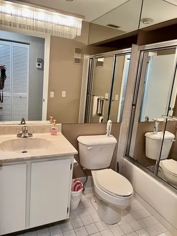 a white toilet sitting next to a bathroom sink