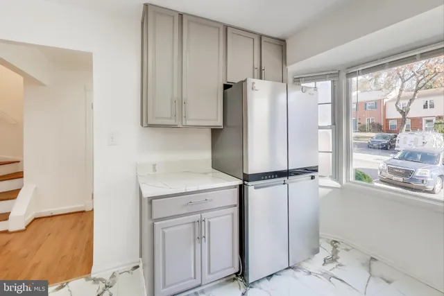 a kitchen with appliances cabinets and a window