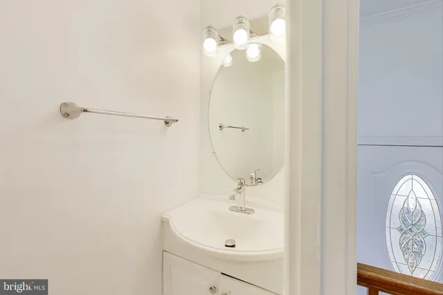 a bathroom with a sink a mirror and vanity