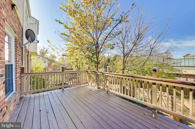 a view of balcony with wooden floor and fence