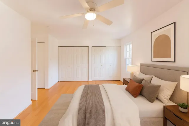 a bedroom with a bed and a painting on the wall