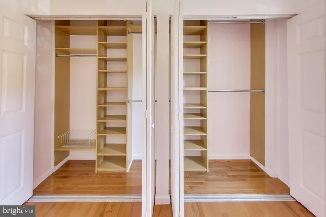 a view of a bedroom with wooden floor and closet