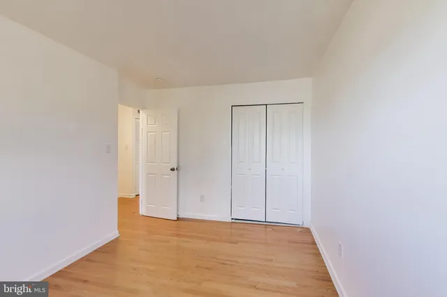 a view of an empty room and wooden floor