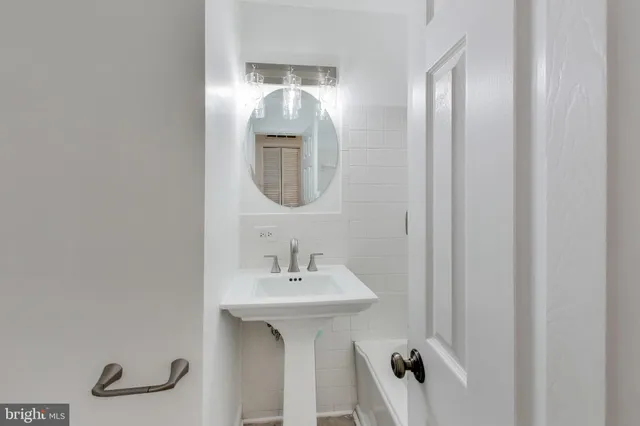 a bathroom with a sink a mirror and shower