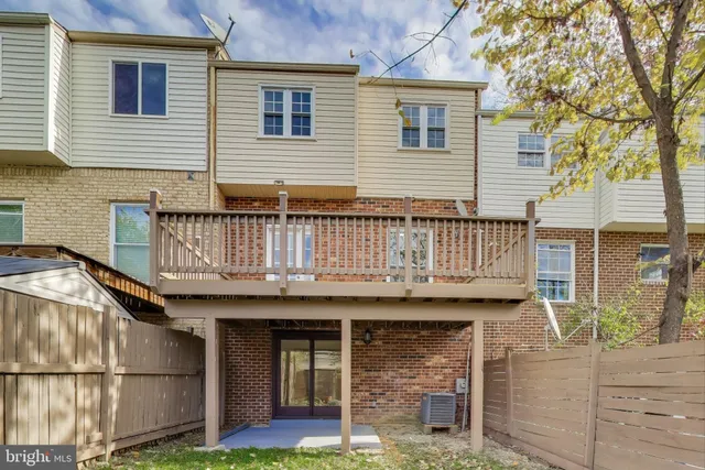 a view of a house with wooden deck