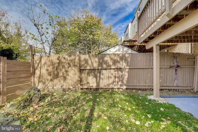 a sign board with yard in the back