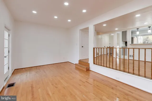 a view of an empty room with wooden floor