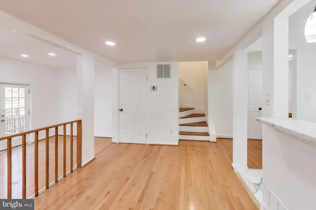 a view of a hallway with wooden floor