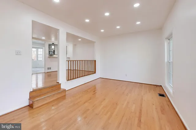 a view of an empty room with wooden floor