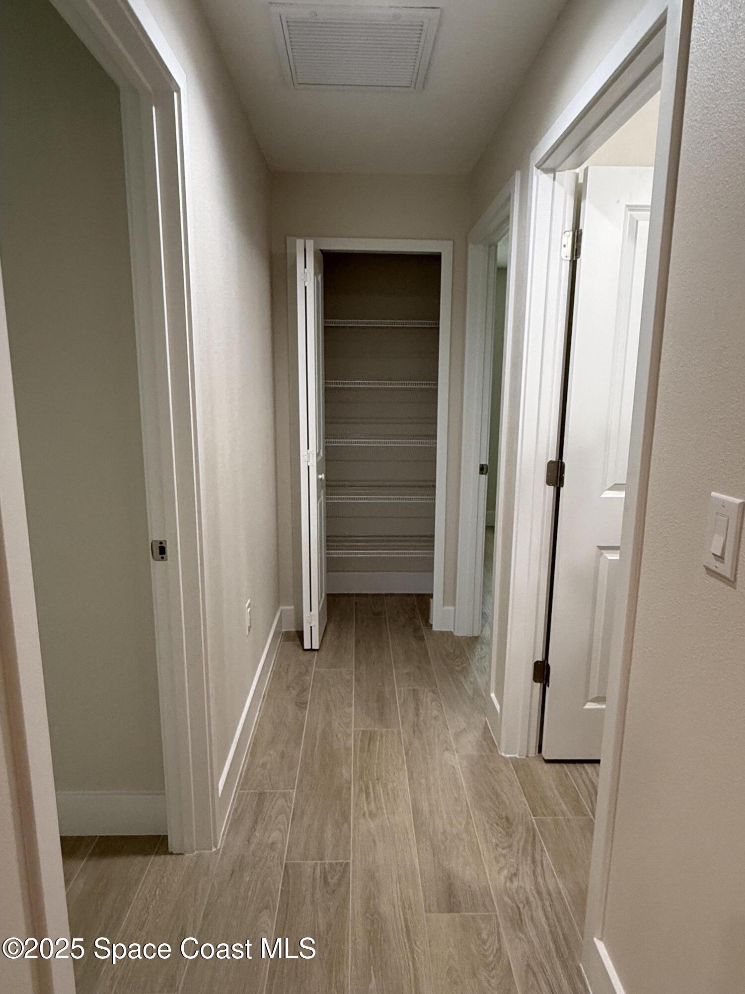 581 Toynbee Road Palm Bay, FL 32908 - Photo 12 of 25 a view of a room with wooden floor