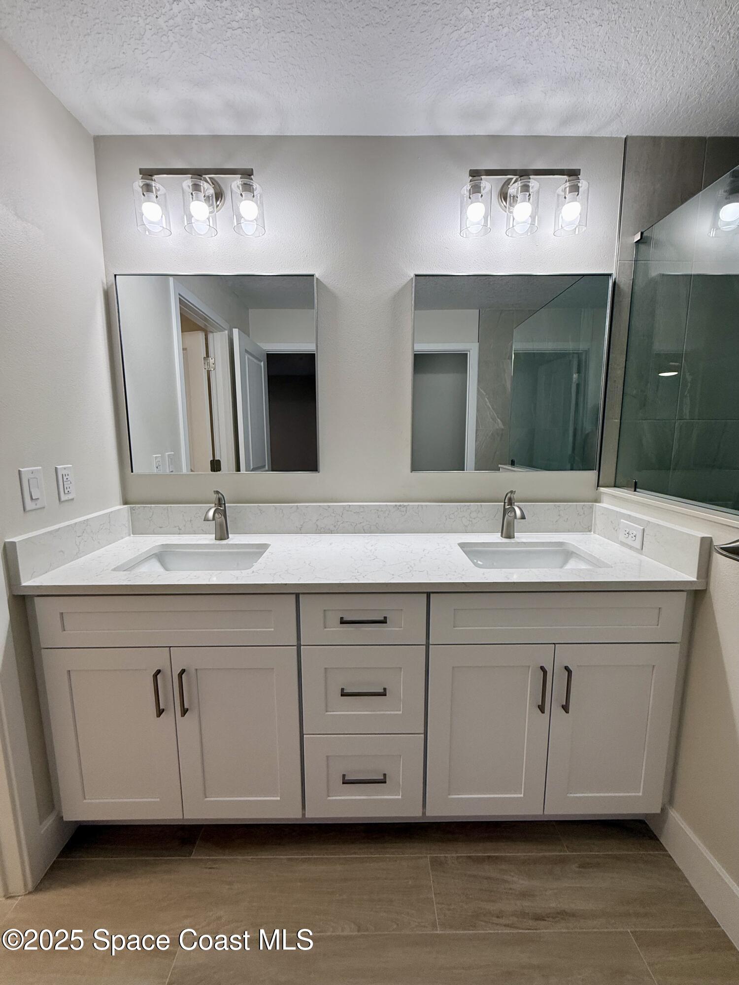 581 Toynbee Road Palm Bay, FL 32908 - Photo 16 of 25 a bathroom with a double vanity sink and a mirror